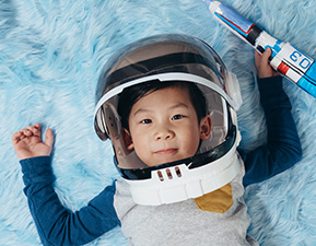 cute asian child in an astronaut suit